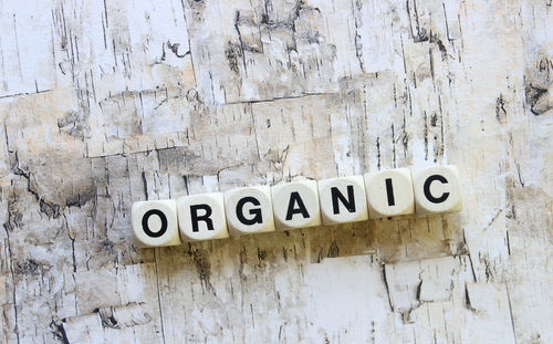 Close-up of organic text made from dice on wooden table