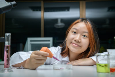 Girl scientist using dropper with rubber test. education and science concept