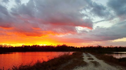 Scenic view of lake against sky during sunset