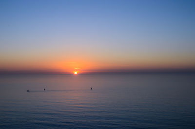 Scenic view of sea against clear sky during sunset