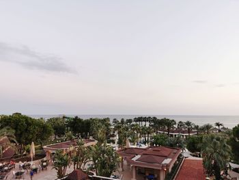 High angle view of buildings and sea against sky
