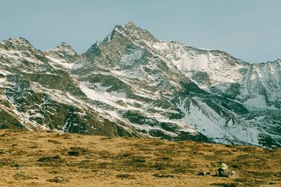 Scenic view of snowcapped mountains against clear sky