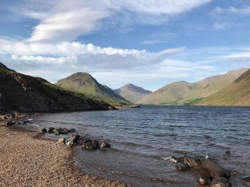 Scenic view of lake and mountains against sky