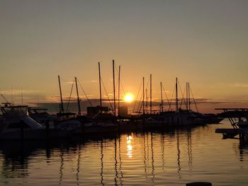 Boats in marina at sunset