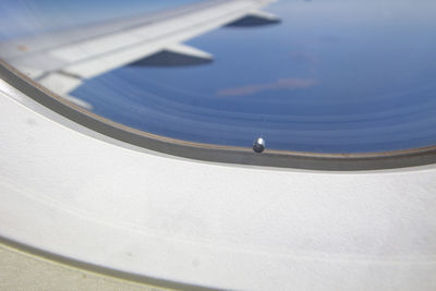 Close-up of a small hole in the aircraft window.