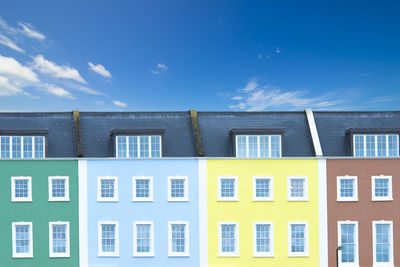 Multi colored buildings against blue sky