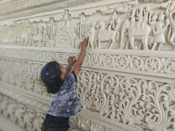 Full length of man standing against wall