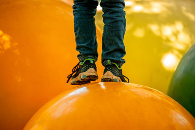 Low section of man standing by pumpkin