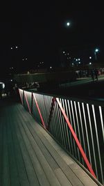 Illuminated bridge in city at night