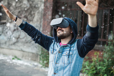 Man wearing virtual reality simulator with cottonwood fluff in mid-air