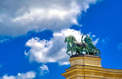 Low angle view of statue against blue sky