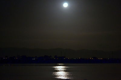 Illuminated lights against sky at night