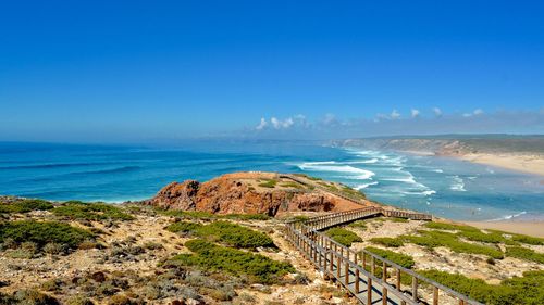 Scenic view of sea against blue sky