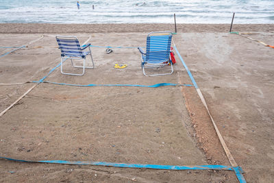 High angle view of chairs on beach