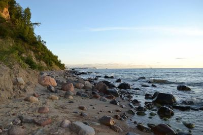 Rocks on beach against sky