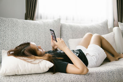 Midsection of woman using mobile phone
