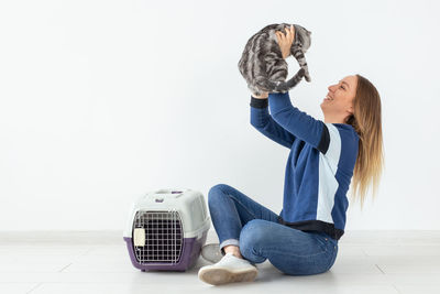 Woman wearing hat on floor against white background