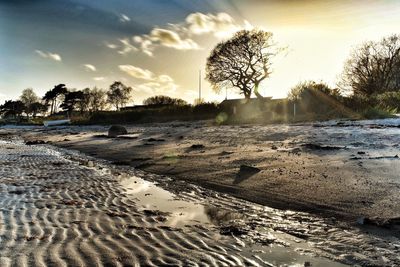 Scenic view of beach against sky during sunset