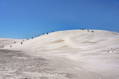 Scenic view of desert against clear blue sky