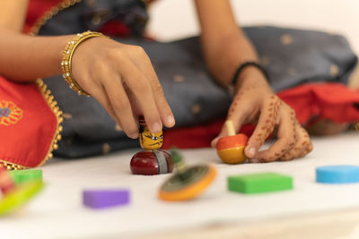 Close-up of woman preparing food on table