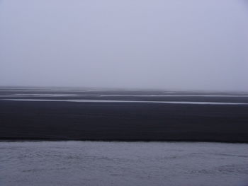 Scenic view of sea against clear sky during winter