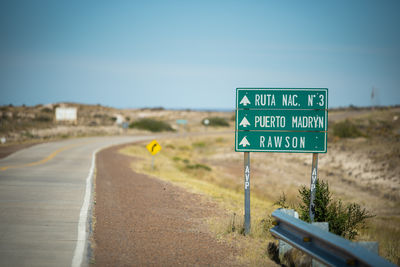 Road sign against clear blue sky