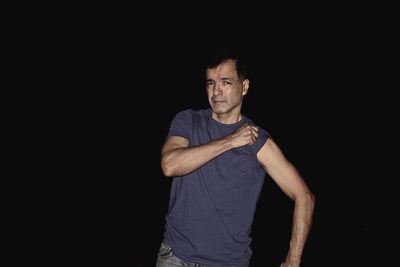 Portrait of mid adult man standing at night