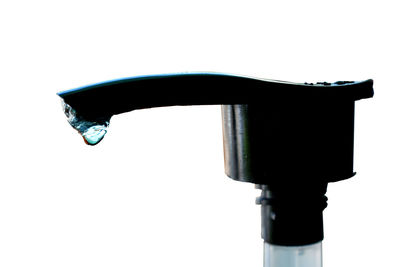 Close-up of water faucet against white background