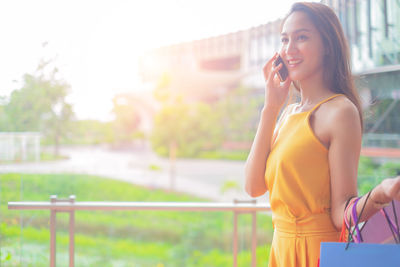 Young woman using mobile phone outdoors