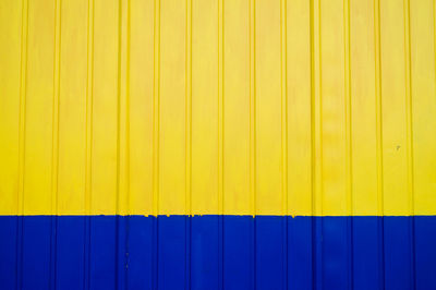 Full frame shot of yellow and blue corrugated wall
