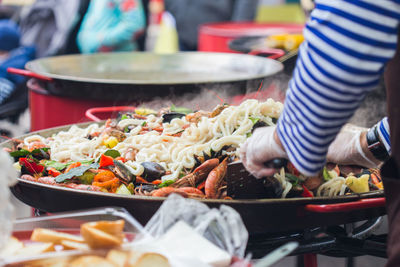 Midsection of person preparing food at market