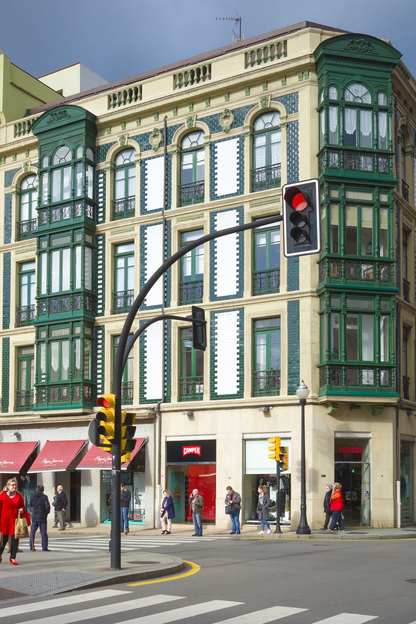 PEOPLE ON STREET AGAINST BUILDINGS