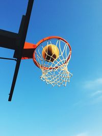 Low angle view of basketball hoop against blue sky