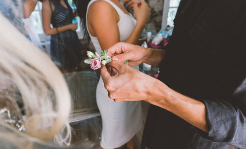 Midsection of person holding flowers