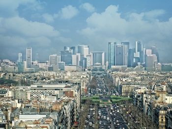 Cityscape against cloudy sky