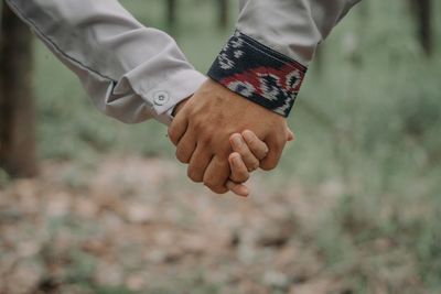 Close-up of man holding hands