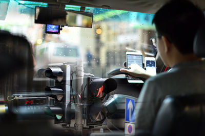 Double exposure of man driving car and road signals