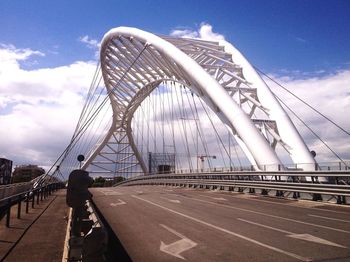 Bridge against cloudy sky