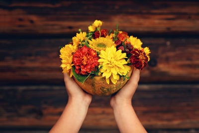 Close-up of hand holding flower bouquet