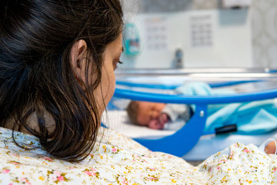 Portrait of woman relaxing on bed