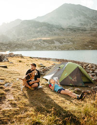 Rear view of woman sitting on tent