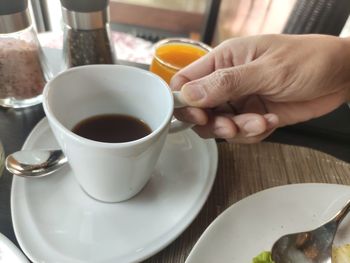 Midsection of coffee cup on table