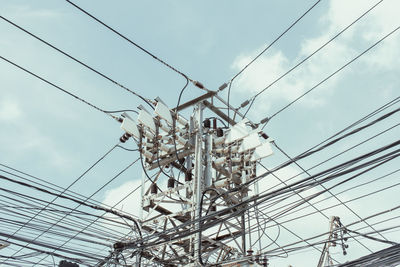 Low angle view of electricity pylon against sky