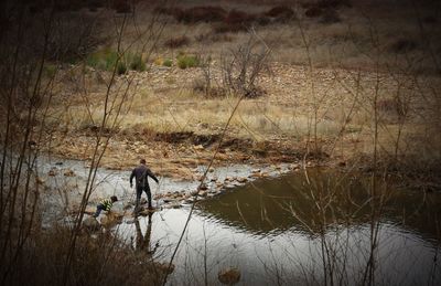 Full length of woman standing in lake