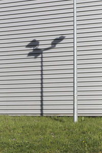 Shadow of closed shutter on wall