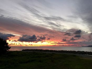 Scenic view of dramatic sky over sea during sunset