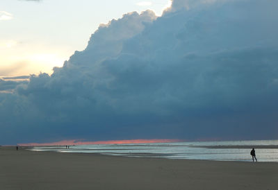 Scenic view of sea against cloudy sky