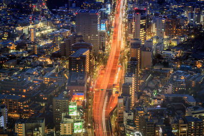 Aerial view of city lit up at night