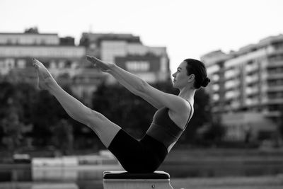 Rear view of woman exercising in park