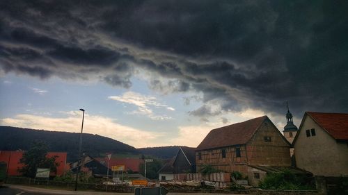 Houses in town against sky